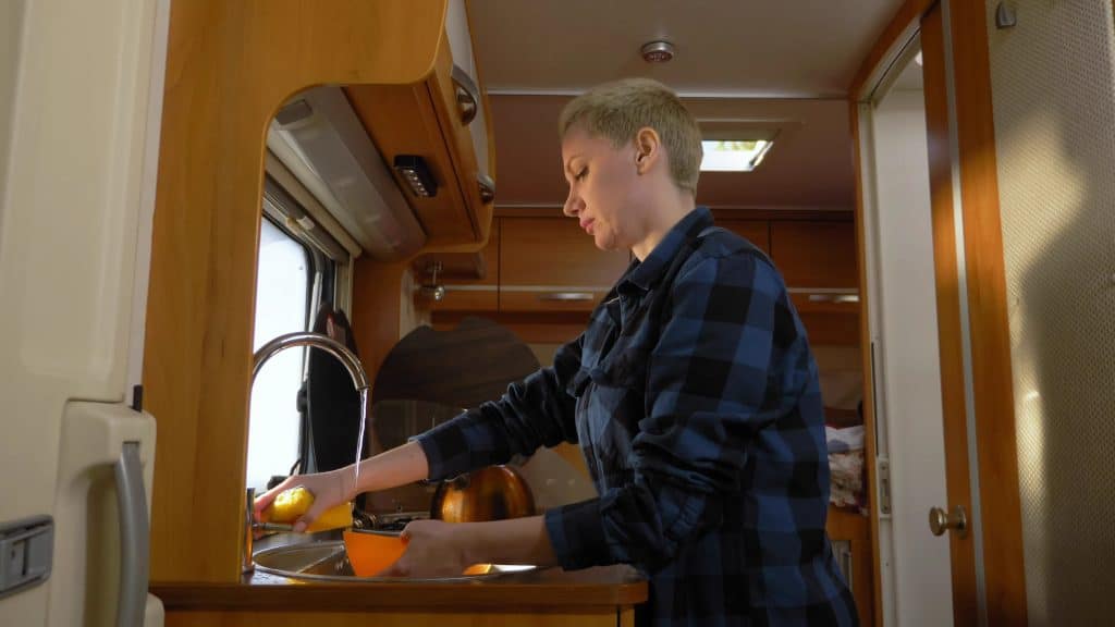 Woman cleaning the inside of an RV